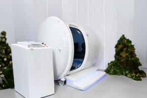 White cylindrical chamber with control unit and decor in a minimalist room.