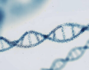 DNA double helix structure formed by small blue particles on a light blurred background